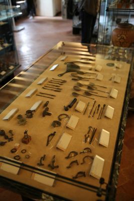 Roman bronzes: amulets, fibulae, small tools, tableware - Showcase n.10, Archaeological Section, Torcello Museum, Venice
